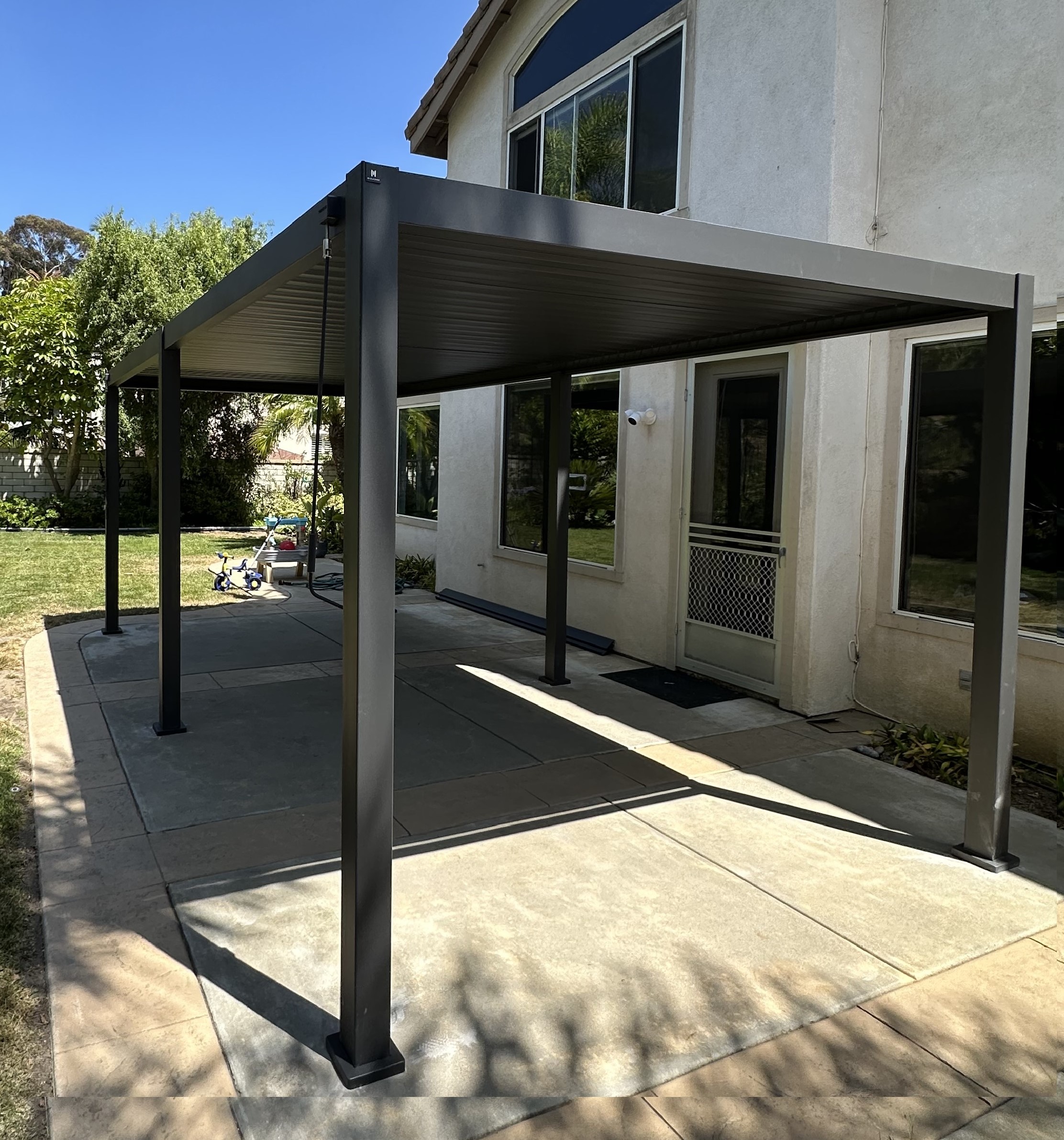 10x12 louvered aluminum pergola on concrete patio side angle